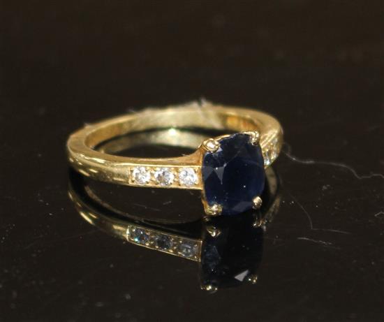 A modern 18ct gold and oval cut sapphire ring, with diamond set shoulders, size M, gross weight 3.4 grams.